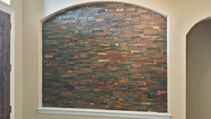 A textured stone inset framed by a soft arch.