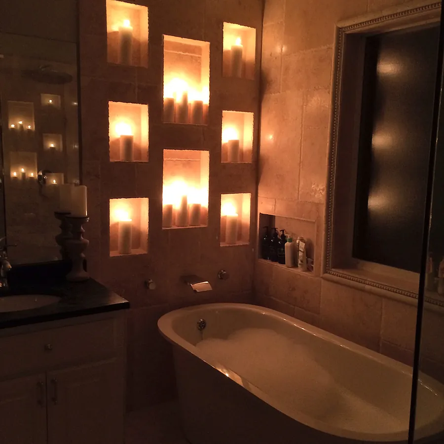 Warm interior lighting around a built-in bathing area.