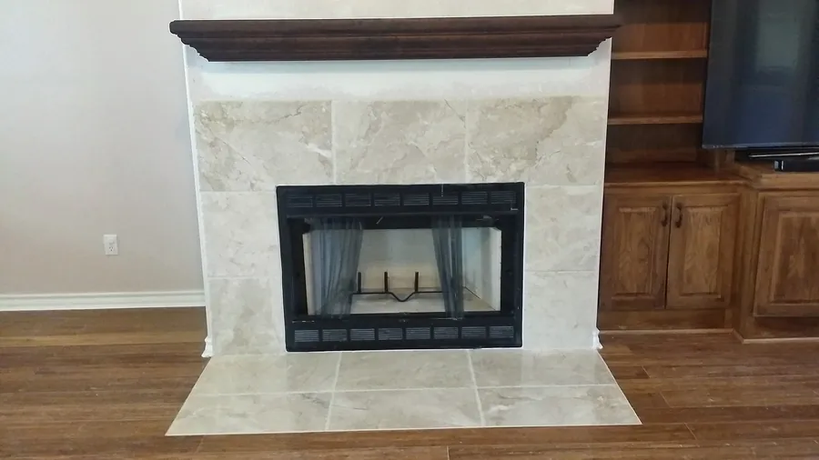 Stone-clad fireplace with sleek dark firebox.