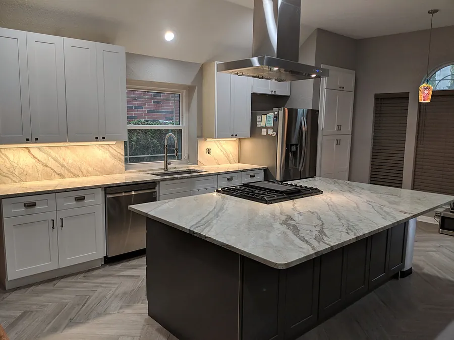 An open kitchen centered on a substantial stone-look island.