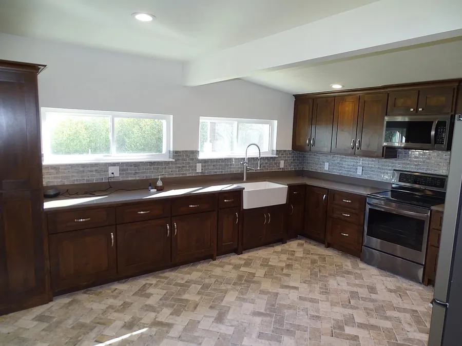 A traditional kitchen with stone-patterned tile flooring.