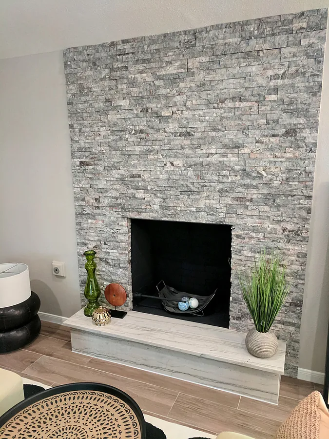 Vertical stone texture around a contemporary fireplace.