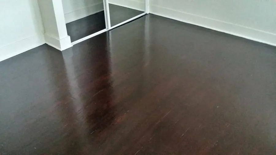 Deep wood-tone floor planks in a bright interior.