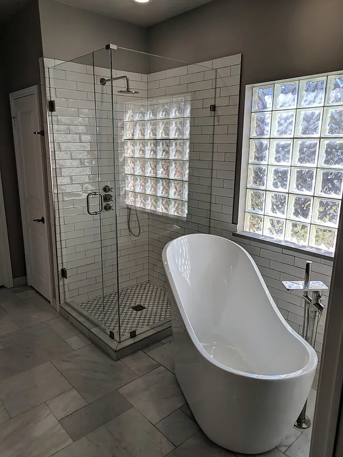 Renovated bathroom with freestanding tub and a tiled walk-in shower