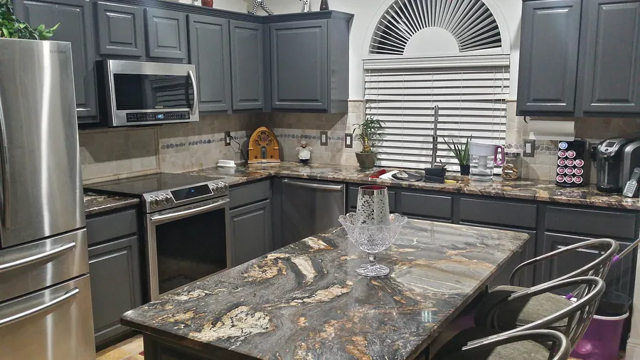 A dramatic countertop paired with deep-toned cabinetry.