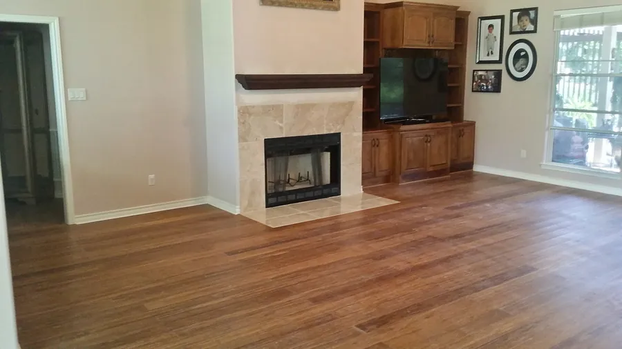 Continuous wood flooring and a stone-faced fireplace.