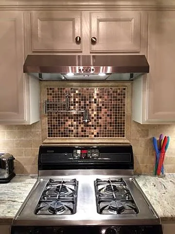 Decorative tile accent behind the cooking area.